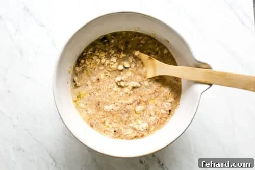 Comforting Apple Raisin Oatmeal Bake 14 Wet and dry ingredients combined in a large bowl to form baked oatmeal batter.