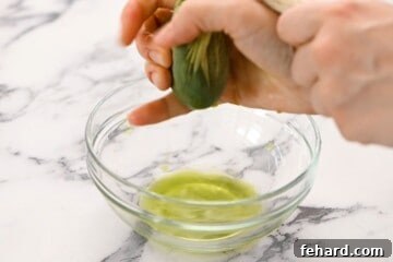 Spinach Pizza 9 Spinach in cheesecloth being wrung dry over clear bowl.