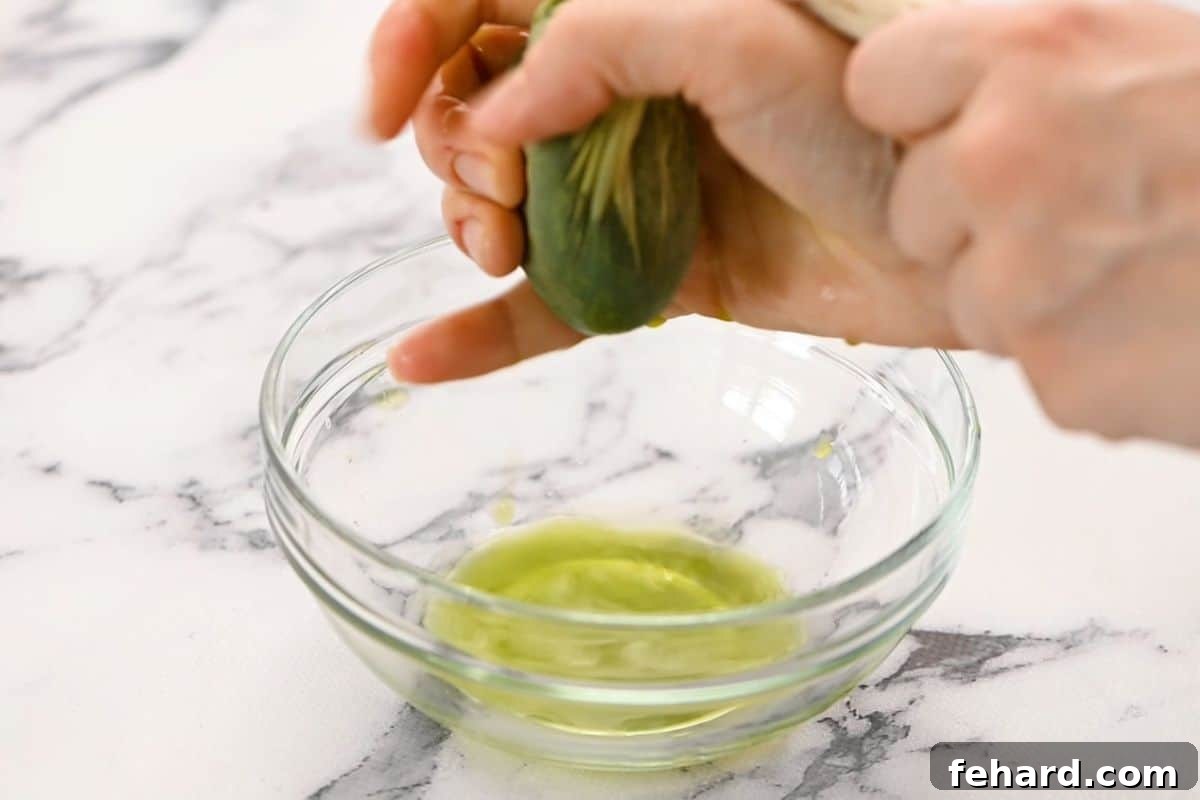 How to Squeeze Spinach Dry Spinach in cheesecloth being wrung dry over clear bowl, demonstrating the crucial step of removing excess water.