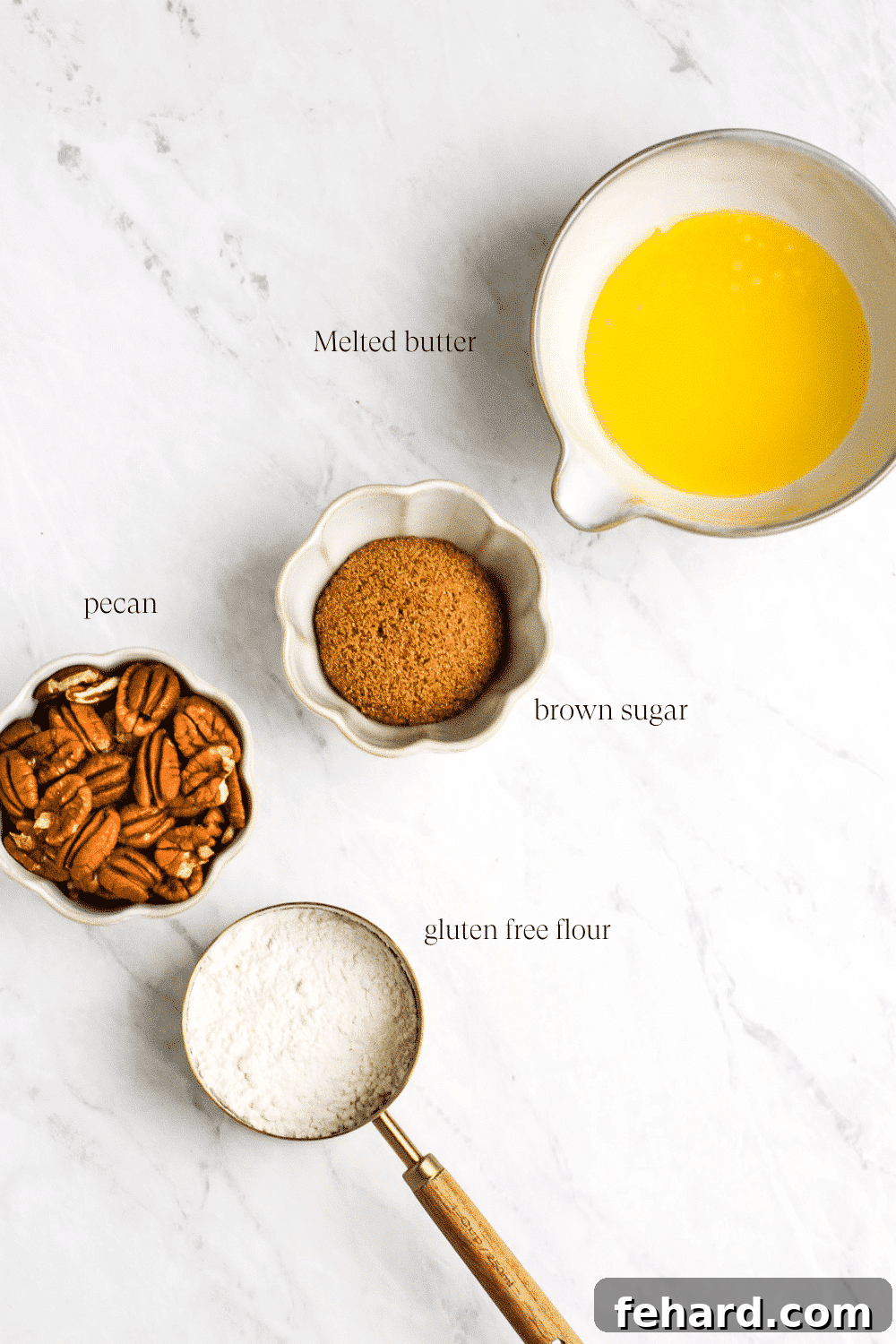 Overhead view of the ingredients for the pecan streusel topping, with melted butter, brown sugar, gluten-free flour, and chopped pecans in separate small bowls.