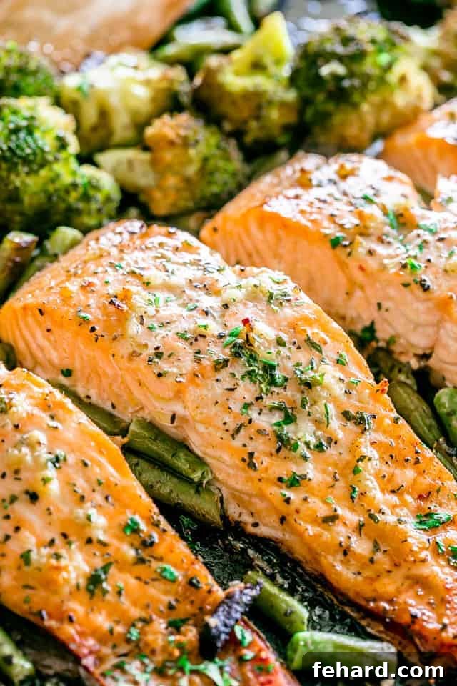 Any Night Salmon Dinner Recipes Baked Pan Seared or Broiled 8 Three pieces of perfectly baked fish on a baking sheet, accompanied by vibrant green beans and broccoli.
