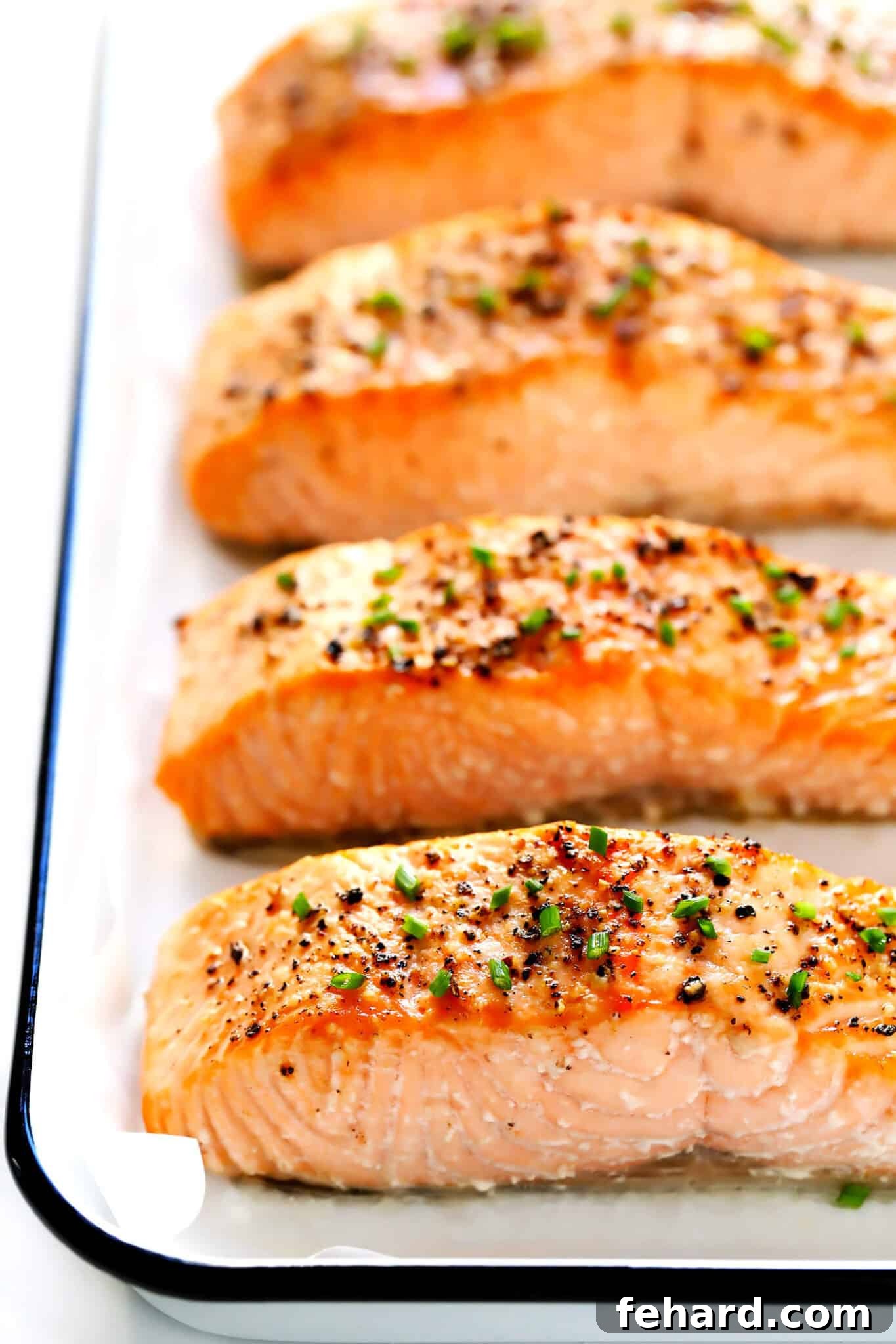 Any Night Salmon Dinner Recipes Baked Pan Seared or Broiled 9 Three savory pieces of fish arranged neatly on a baking sheet.