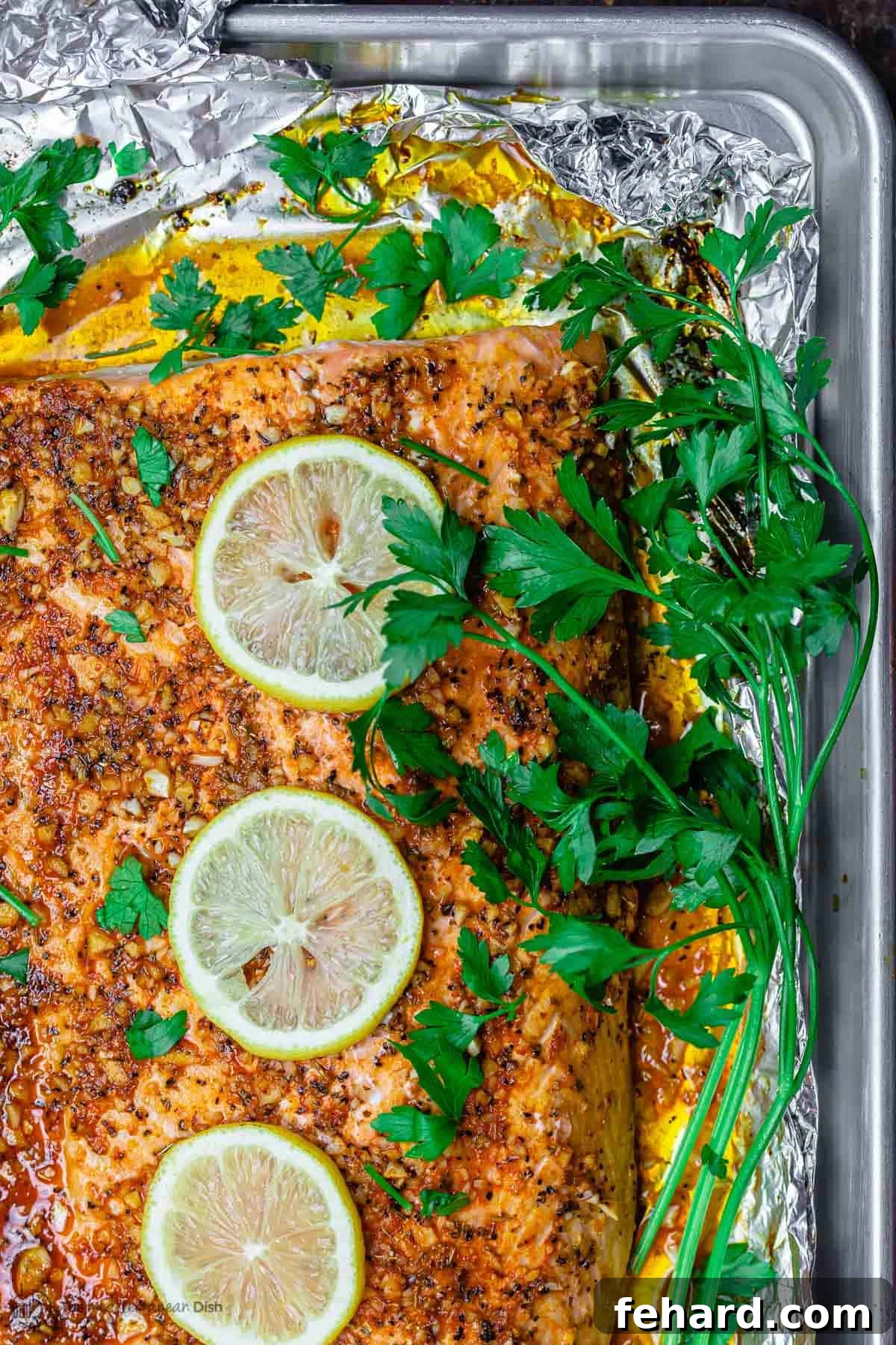 Any Night Salmon Dinner Recipes Baked Pan Seared or Broiled 12 An overhead view of a perfectly cooked salmon fillet, presented on a baking sheet.