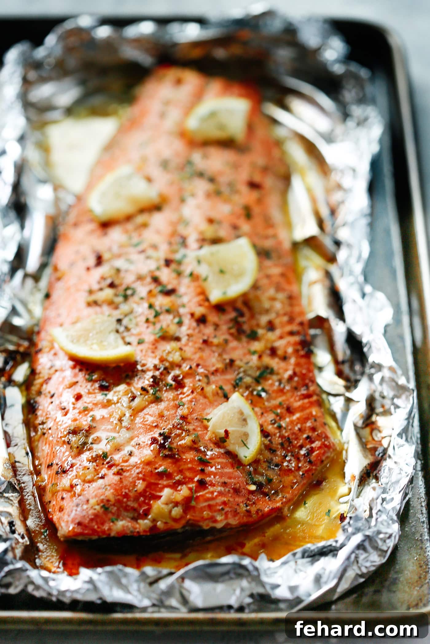 Any Night Salmon Dinner Recipes Baked Pan Seared or Broiled 14 A close-up shot of a salmon fillet, beautifully cooked on a baking sheet.