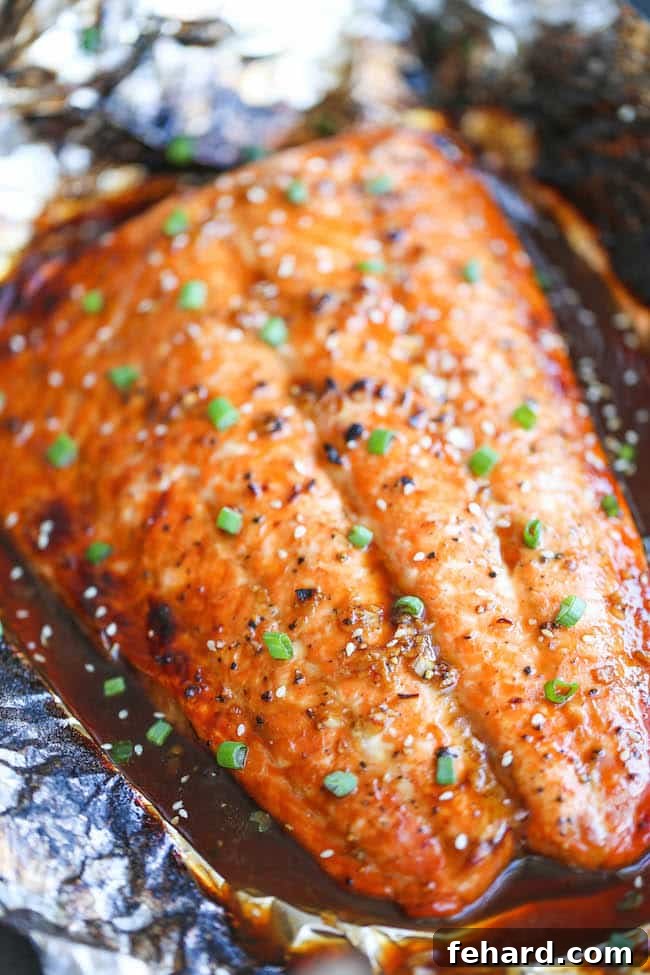 Any Night Salmon Dinner Recipes Baked Pan Seared or Broiled 17 Easy Asian Salmon in Foil, presented on a baking sheet with vibrant garnishes.