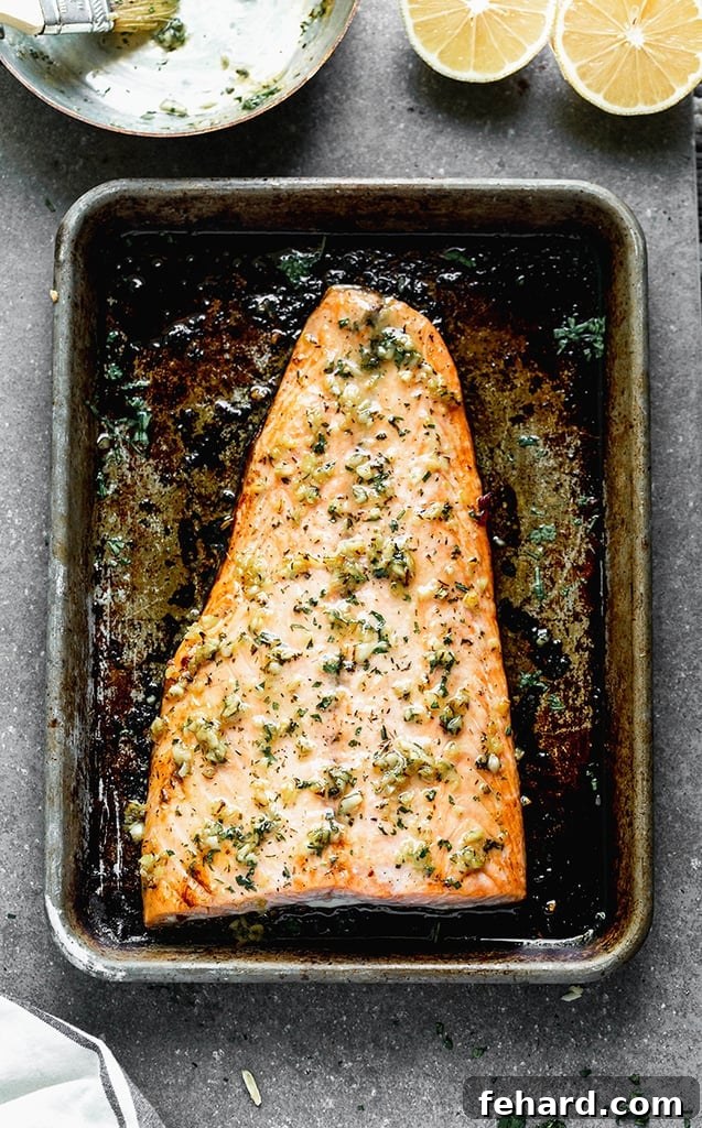 Any Night Salmon Dinner Recipes Baked Pan Seared or Broiled 18 An overhead view of a beautifully baked salmon fillet, seasoned and ready on a baking sheet.
