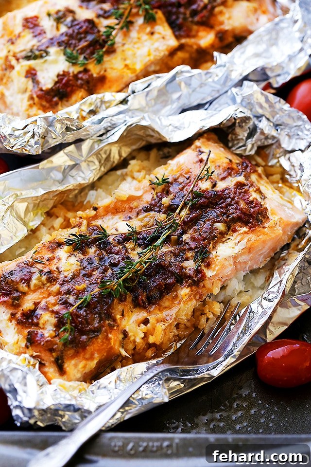 Any Night Salmon Dinner Recipes Baked Pan Seared or Broiled 20 A close-up view of savory Pesto Salmon and Rice, baked to perfection in foil.