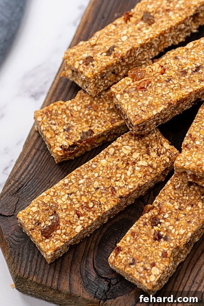 Best Homemade Granola Bar Recipe Delicious homemade no-bake granola bars, perfectly cut into individual portions and arranged on a rustic wooden tray, highlighting their soft and chewy texture.
