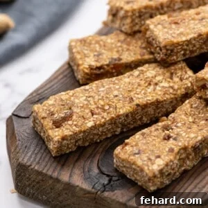 Homemade No-Bake Granola Bars, perfectly cut and arranged on a wooden tray, showing off their irresistible texture.