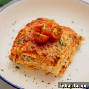 Slice of chicken enchilada casserole on plate.