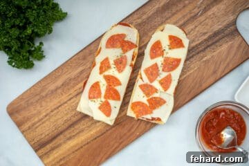 Assembled French Bread Pizza on cutting board before air frying.