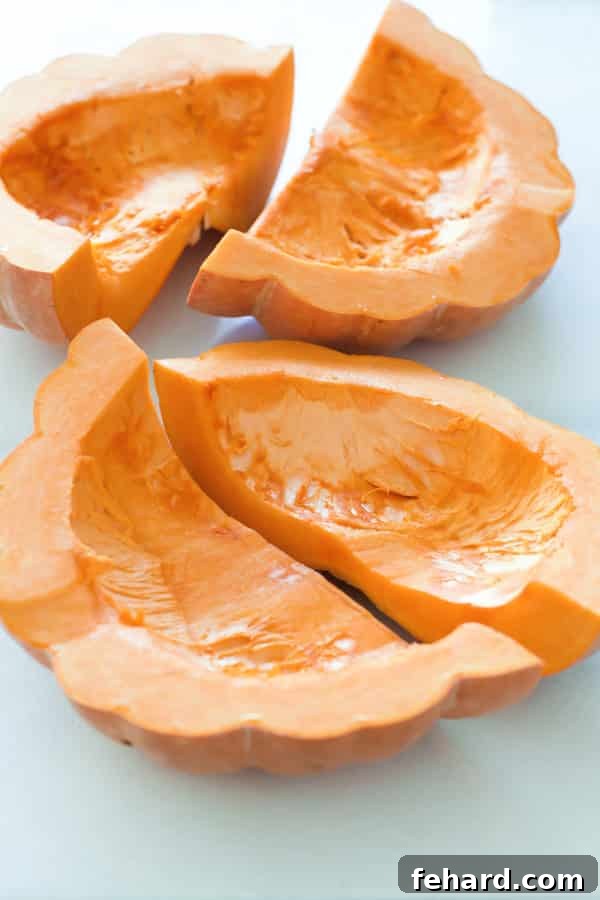 Close-up of pumpkin wedges with fork marks, showing proper preparation for roasting.