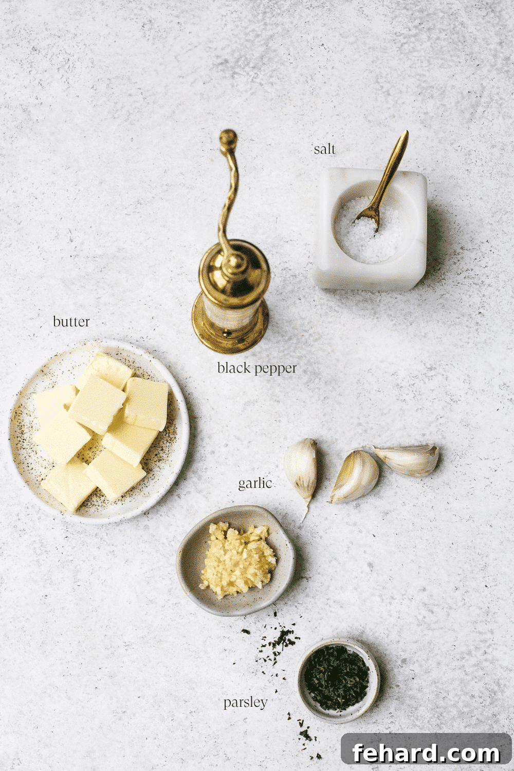 Golden Garlic Spread 3 Ingredients arranged on a white countertop.