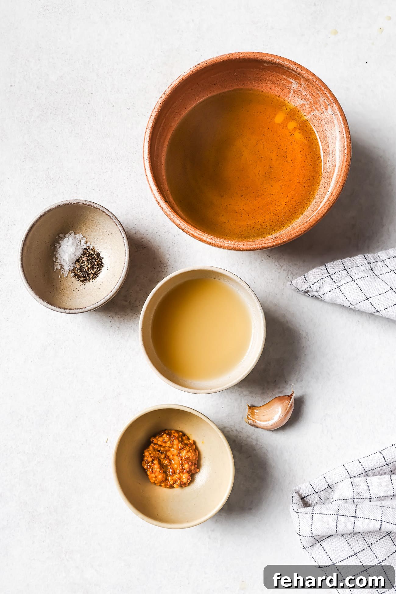 Small bowls of pre-measured ingredients on a white countertop.