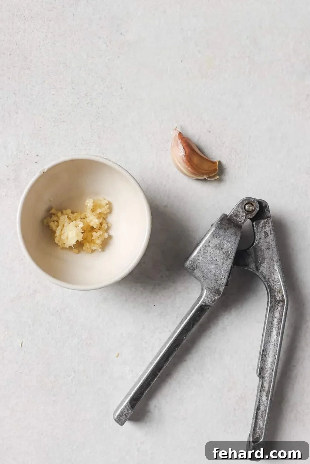 crushed garlic in a white bowl 