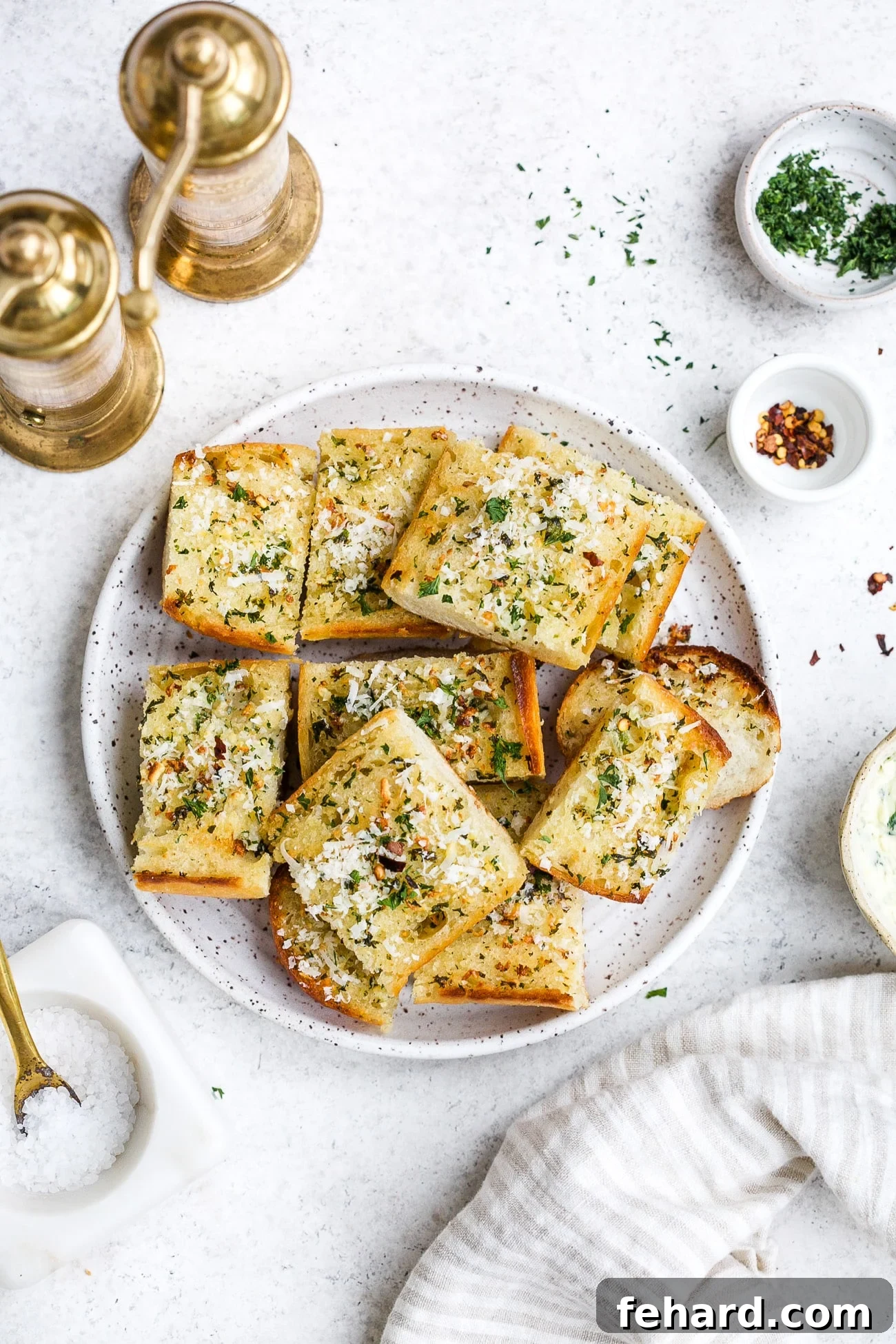 Pieces of garlic bread on a white serving plate.