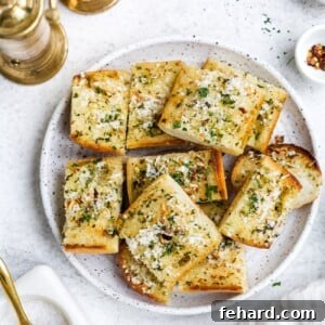 overhead view of garlic bread on a white plate