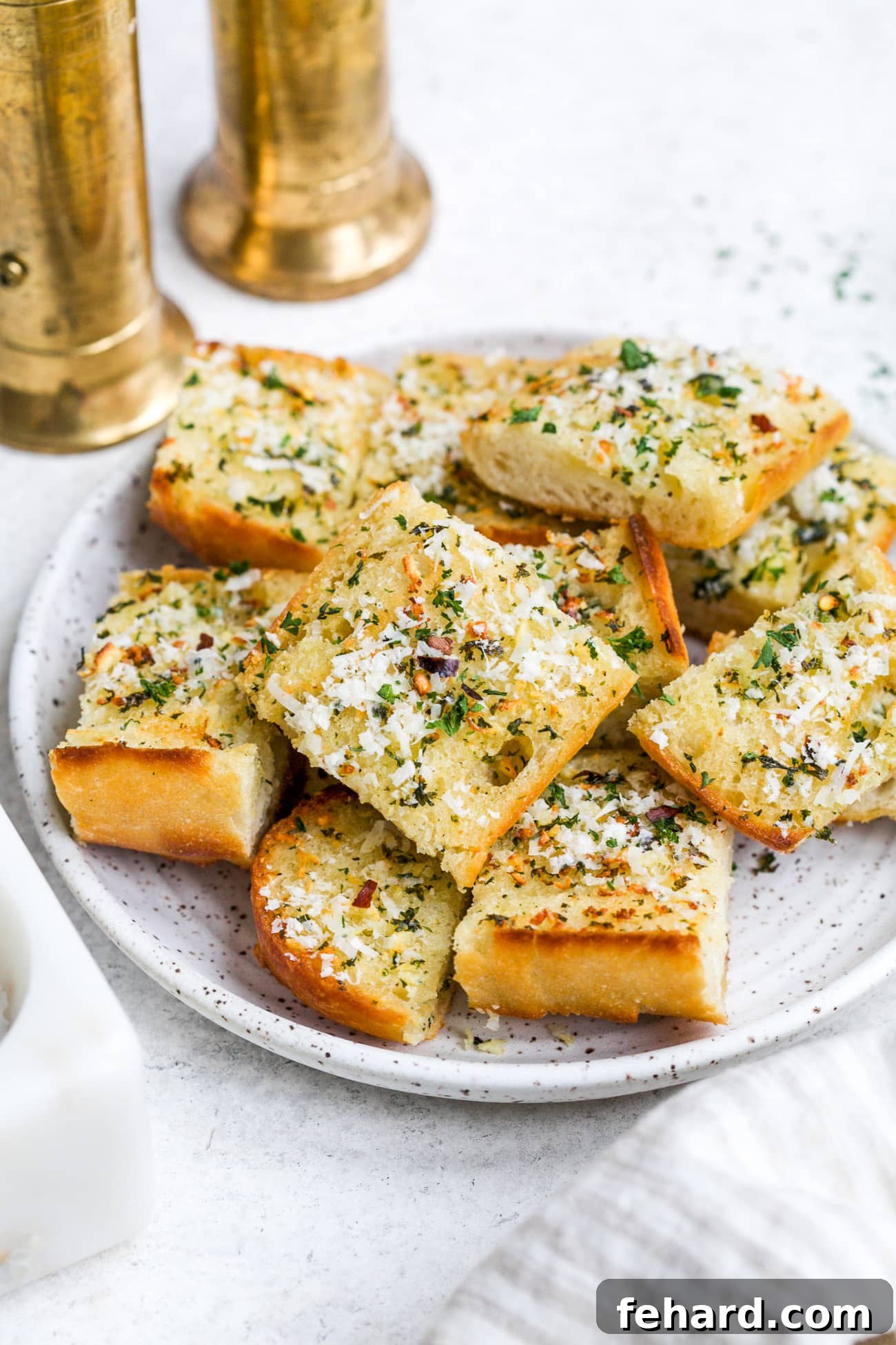 Pieces of garlic bread on a white serving plate.