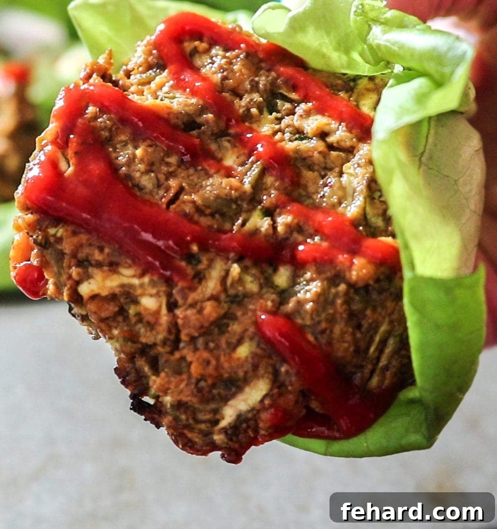 Up close of a Southwestern sweet potato veggie burger served in a crisp lettuce wrap, showcasing its vibrant colors and appealing texture.