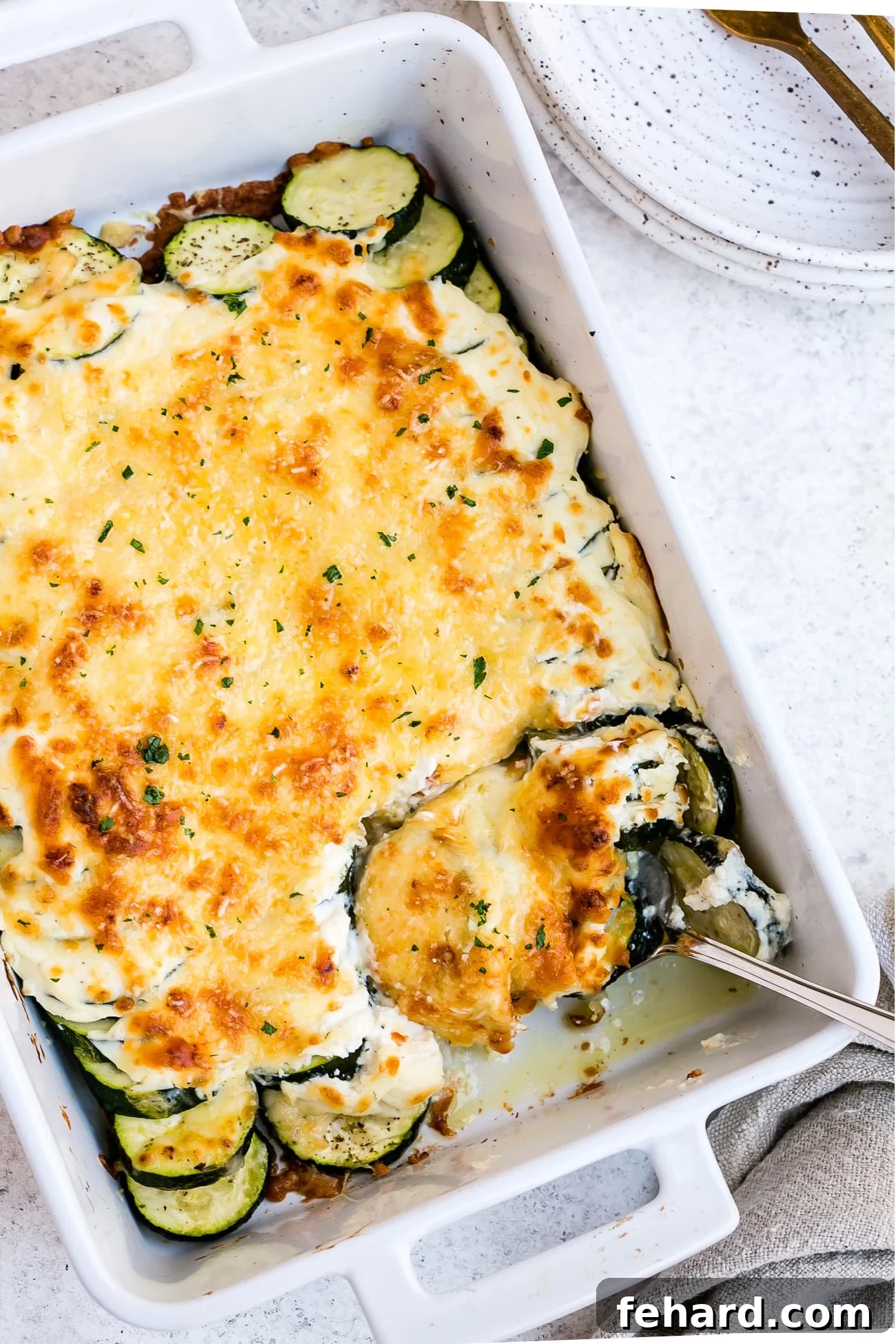 Golden Zucchini Gratin 9 Zucchini casserole in a large, white baking dish.