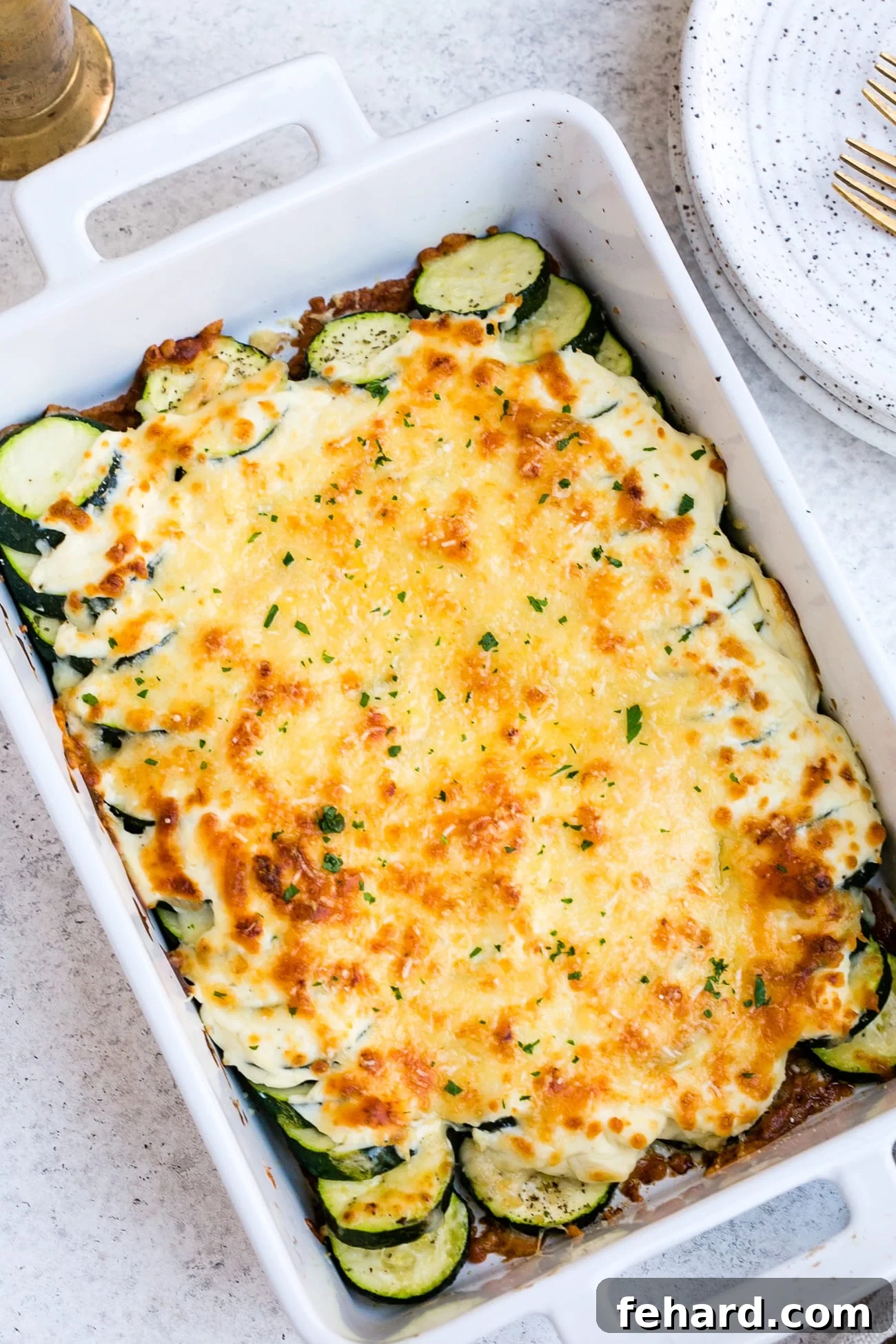Golden Zucchini Gratin 10 Zucchini casserole in a large, white baking dish.