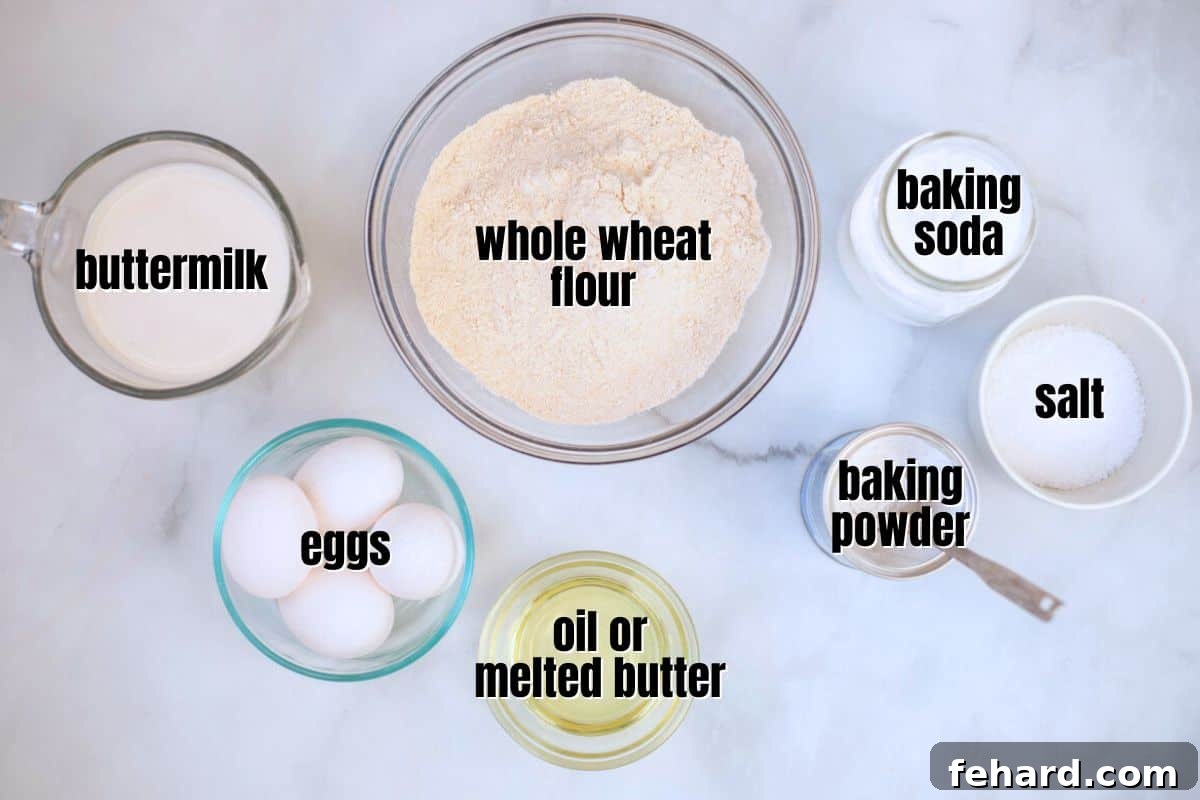 Key Ingredients for Easy Whole Wheat Waffles A selection of raw ingredients for whole wheat waffles, including flour, eggs, oil, and buttermilk, neatly labeled on a kitchen counter.