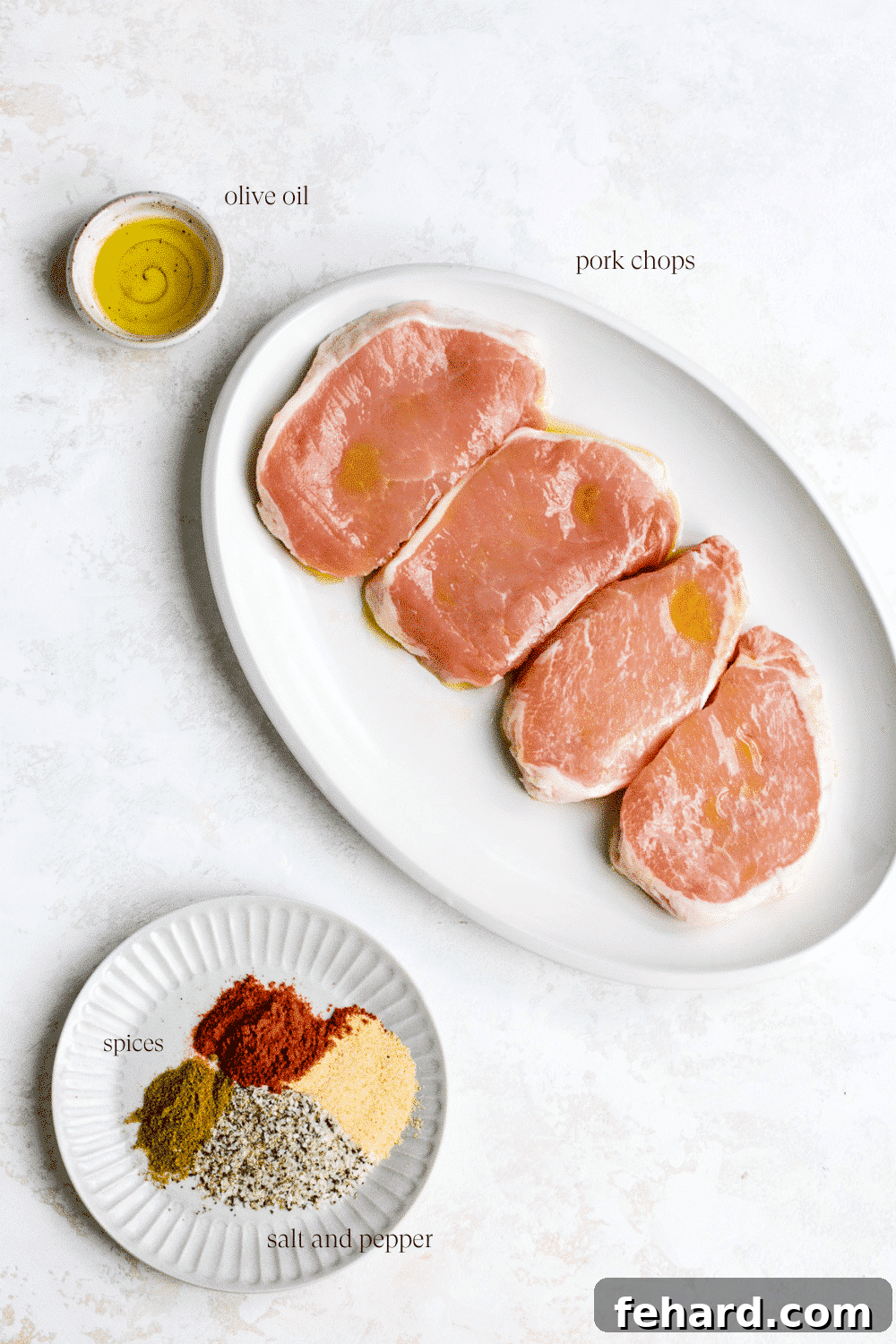 Golden Crispy Air Fryer Pork Chops 3 A collection of ingredients neatly laid out on a cutting board, ready for making air fryer pork chops.