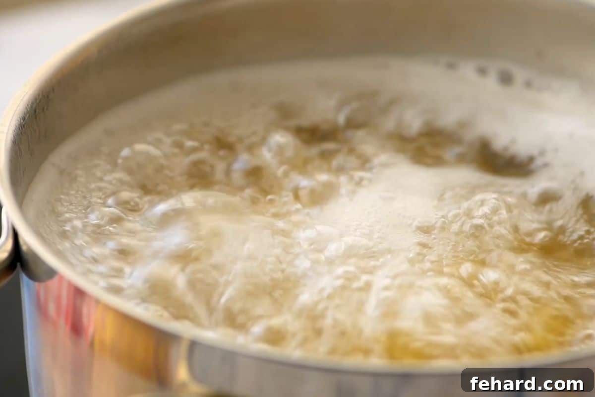 Italian Pasta Salad Recipe Large pot of boiling water with noodles in salted water.