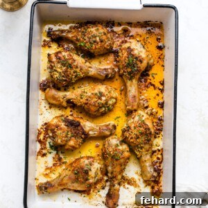 Irresistible Garlic Butter Chicken Legs 9 Garlic butter baked chicken drumsticks in a white baking dish.