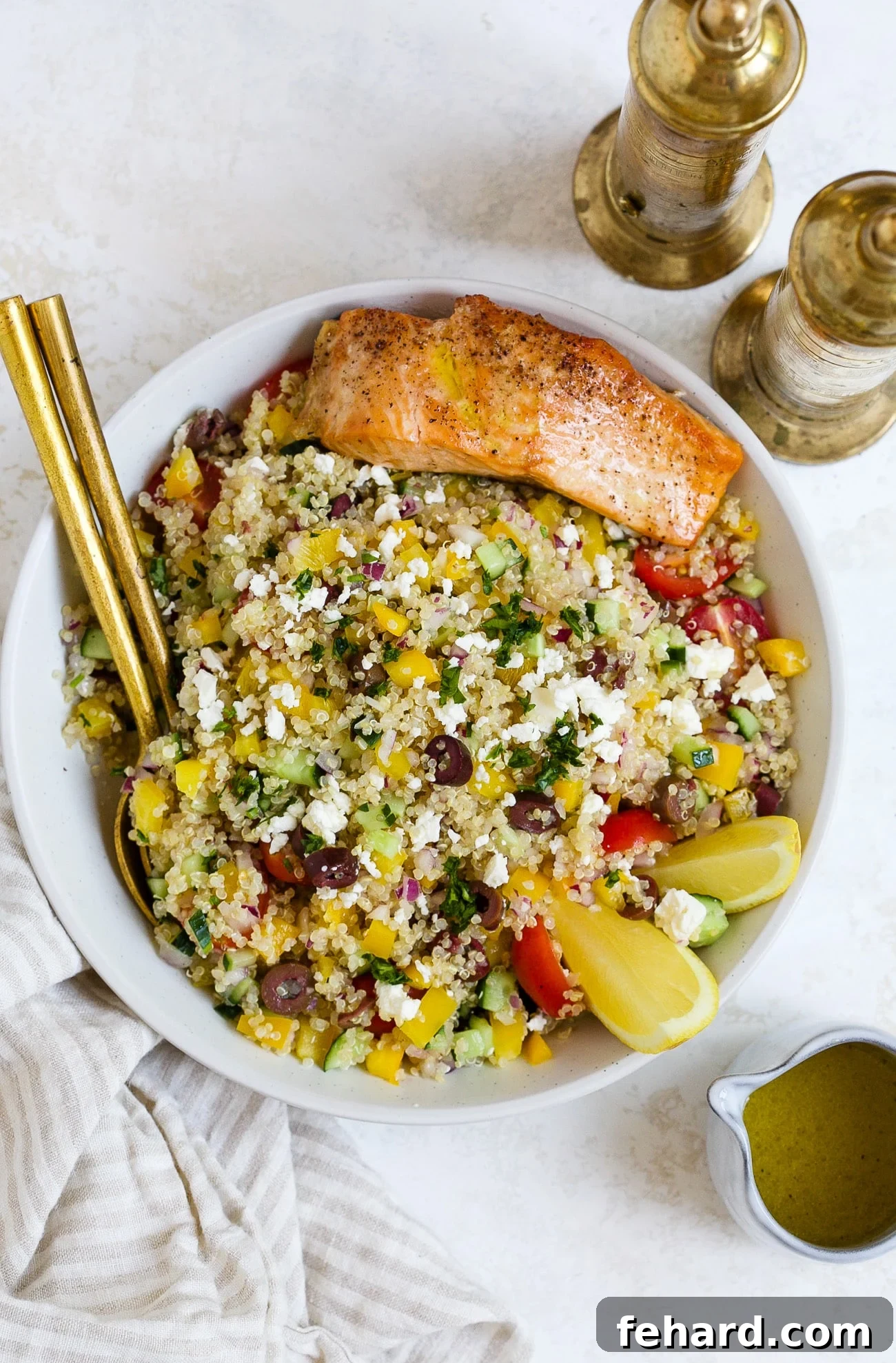 A vibrant Mediterranean quinoa salad overflowing in a beautiful serving bowl, garnished with fresh herbs, showcasing a perfect blend of colors and textures, ready to be enjoyed.
