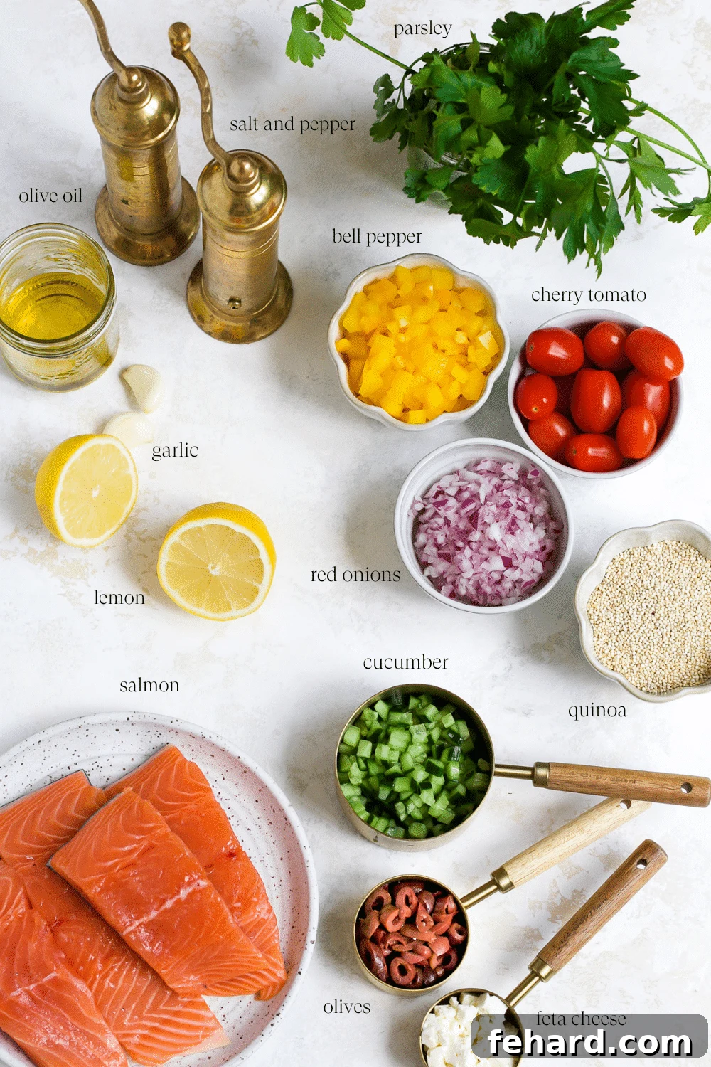 A vibrant flat lay of all the fresh ingredients laid out for the Mediterranean quinoa salad, including cooked quinoa, chopped vegetables, feta, and a bottle of olive oil.