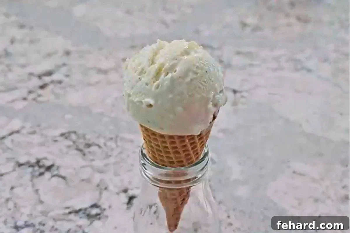 Ice Cream Drumstick Cone Filling Sugar cone topped with a dome of vanilla ice cream, placed in a small glass jar.