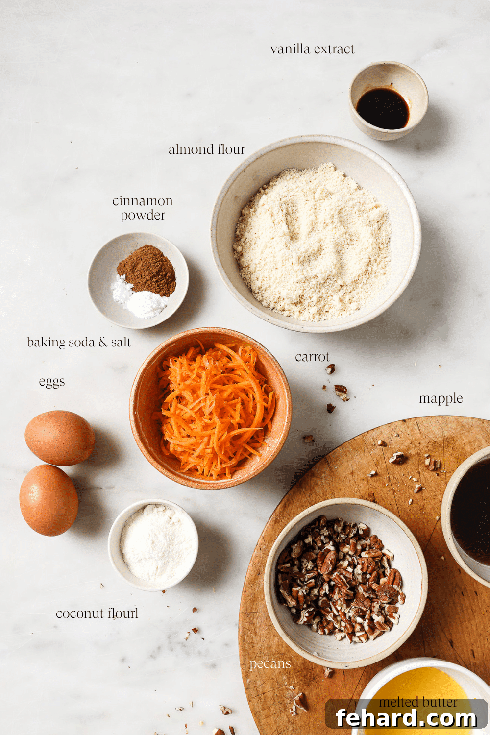 Wholesome Gluten-Free Carrot Muffins 3 Bowls of pre-measured ingredients for gluten-free carrot muffins on a clean white countertop, ready for baking.