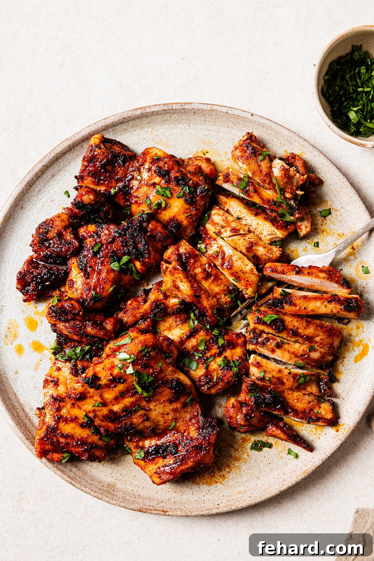 Platter of freshly grilled chicken thighs, perfectly cooked and ready to serve