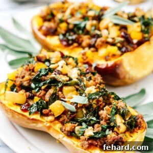 Stuffed butternut squash halves on a white serving plate.