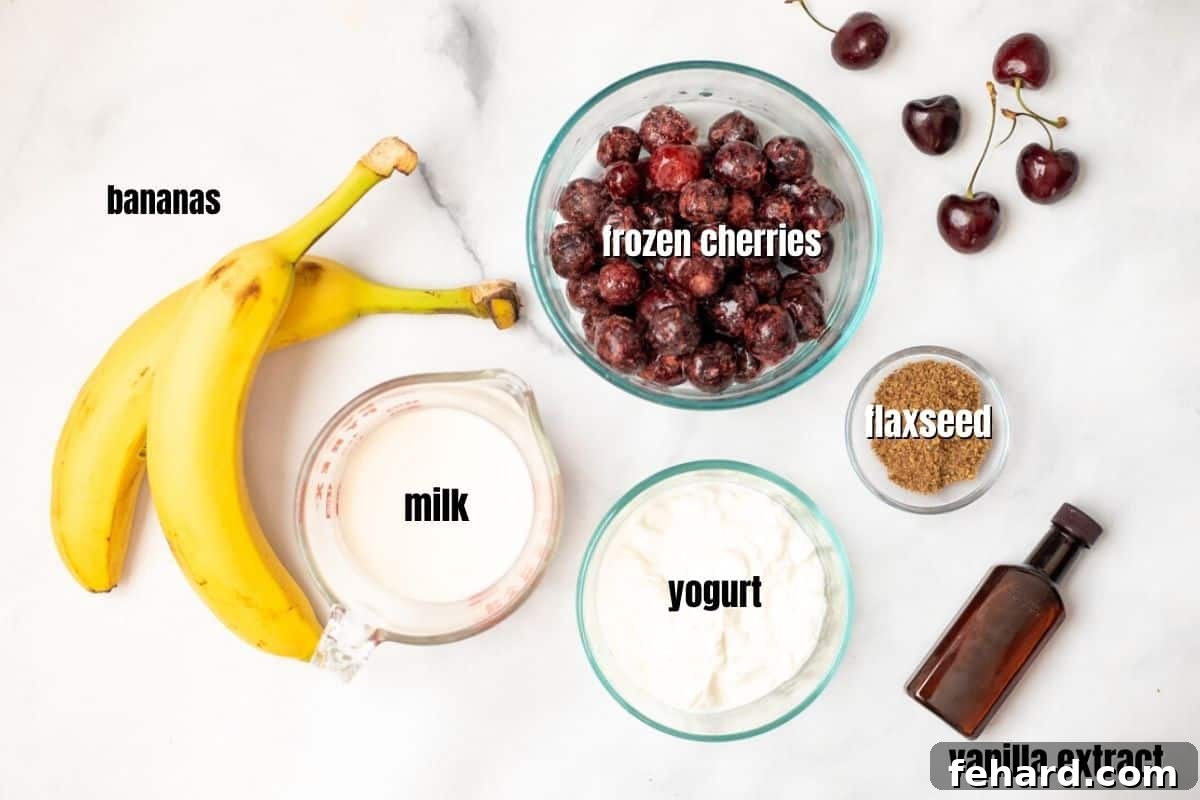 Healthy Cherry Smoothie Ingredients Labeled ingredients for a Cherry Smoothie including fresh and frozen cherries, Greek yogurt, banana, milk, vanilla extract, and ground flaxseed, neatly arranged on a kitchen counter.