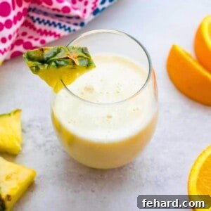 Pina Colada Smoothie ready to serve, garnished with fresh pineapple