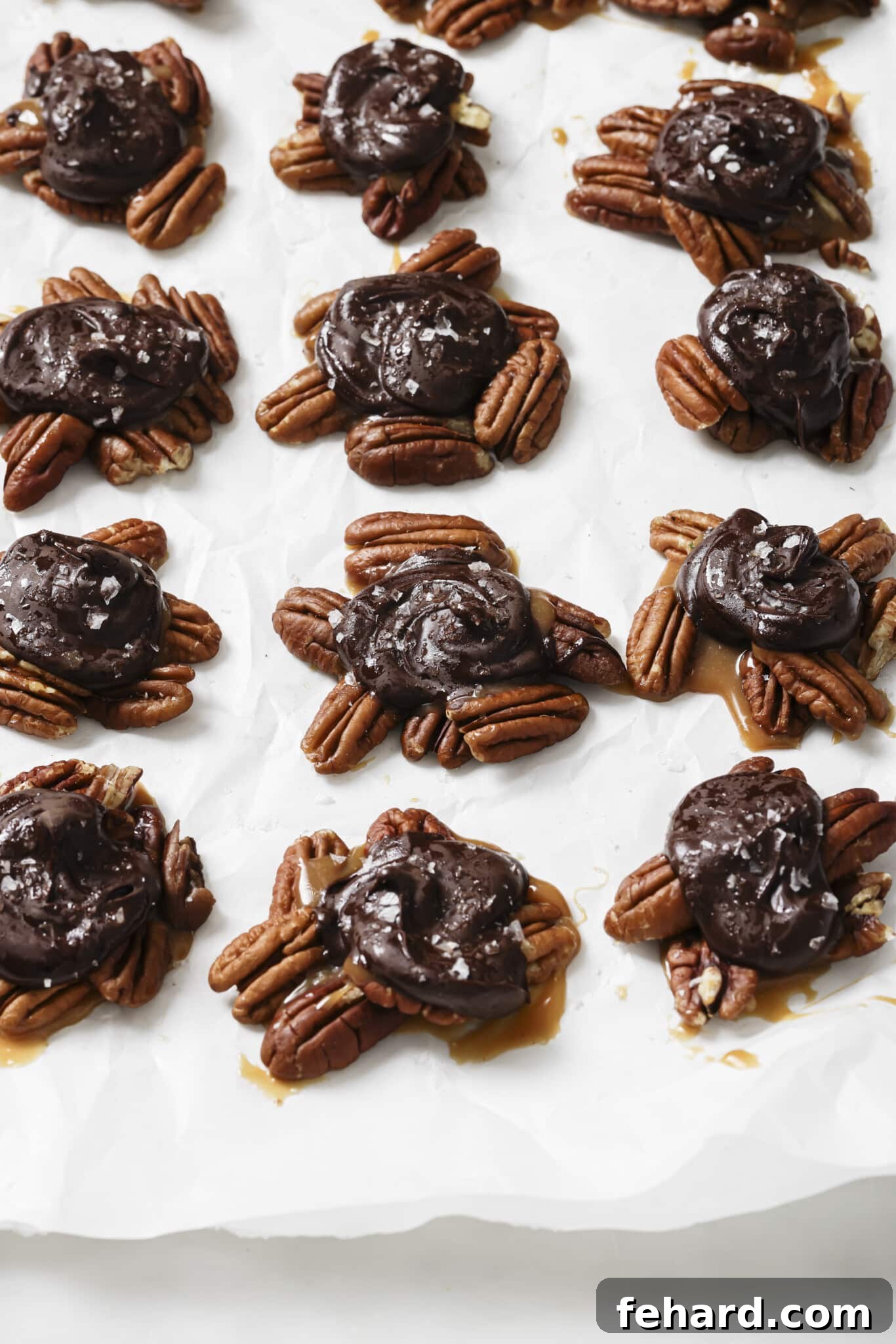 Irresistible Turtle Clusters 7 Close up of Chocolate Turtles on parchment paper, ready to be enjoyed or stored.