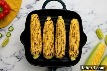 Sunshine Corn Salsa 4 Fresh corn on the cob on a grill plate.