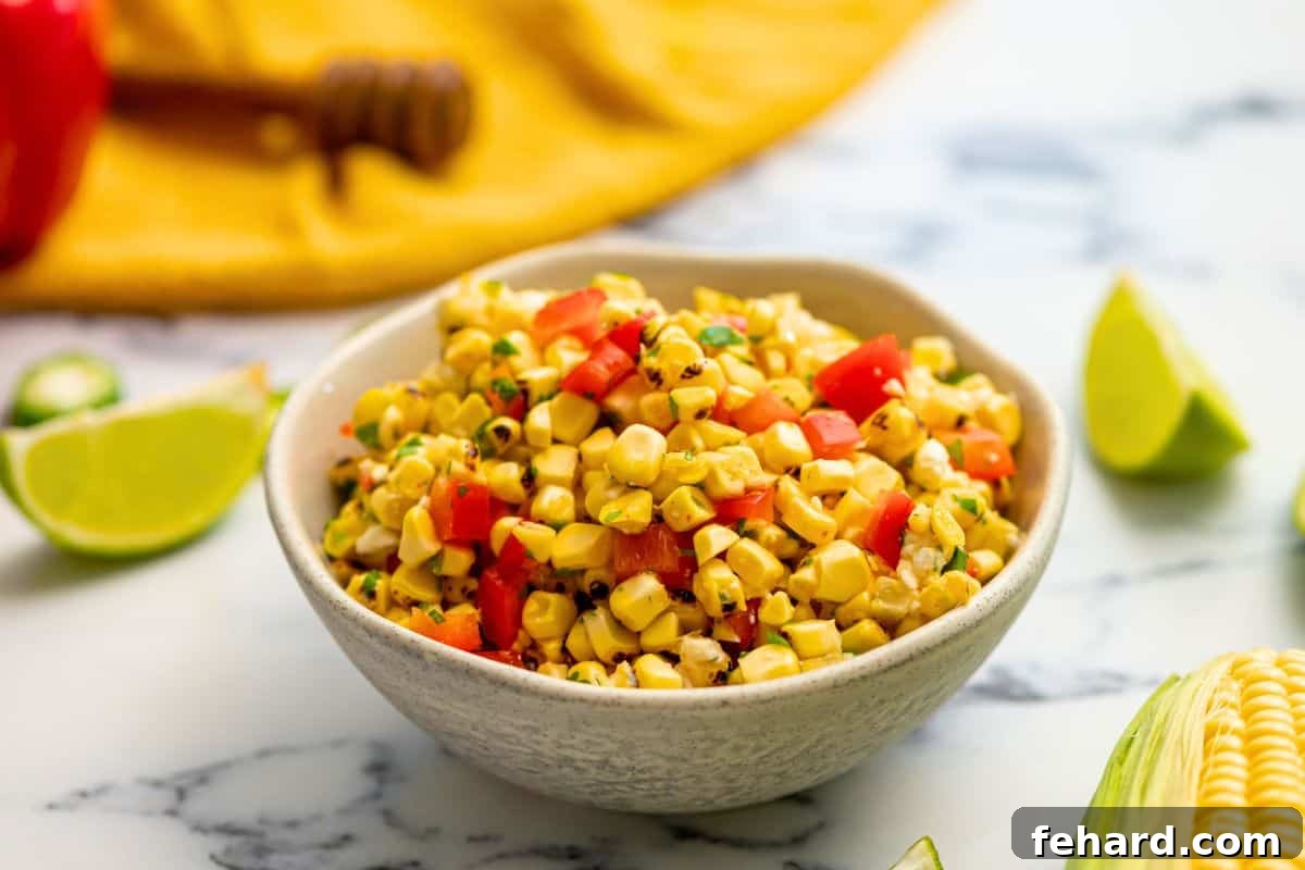 Finished Grilled Corn Salsa A finished bowl of grilled corn salsa, vibrant with red pepper and green cilantro, topped with crumbled cheese.