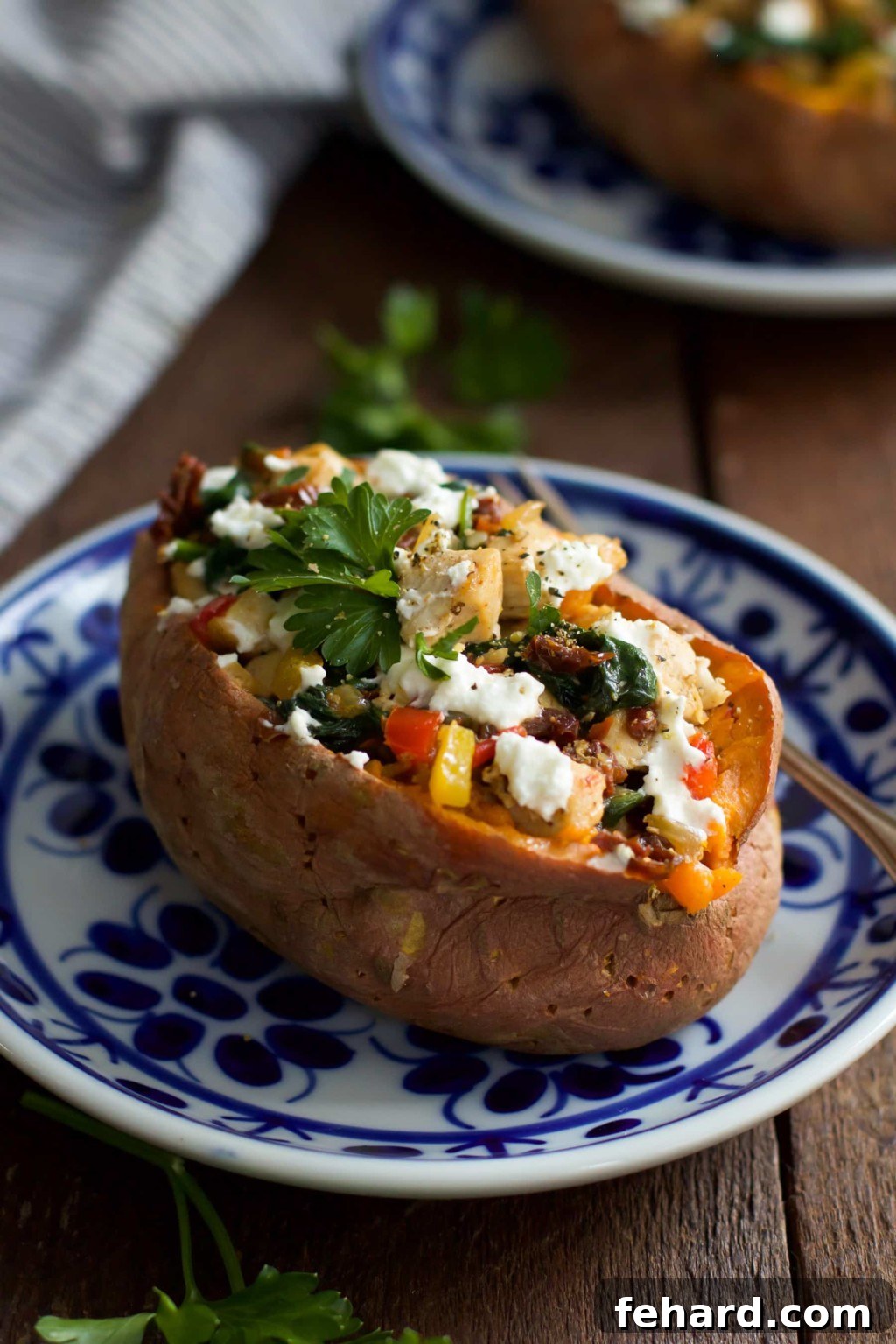 Goat Cheese Chicken Stuffed Sweet Potato Delicious Goat Cheese Chicken Stuffed Sweet Potato on a plate