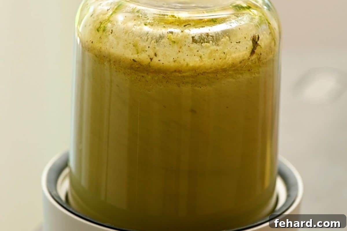 Spicy Grilled Jerk Chicken Skewers 5 Ingredients for jerk marinade being blended in a small food processor or blender.