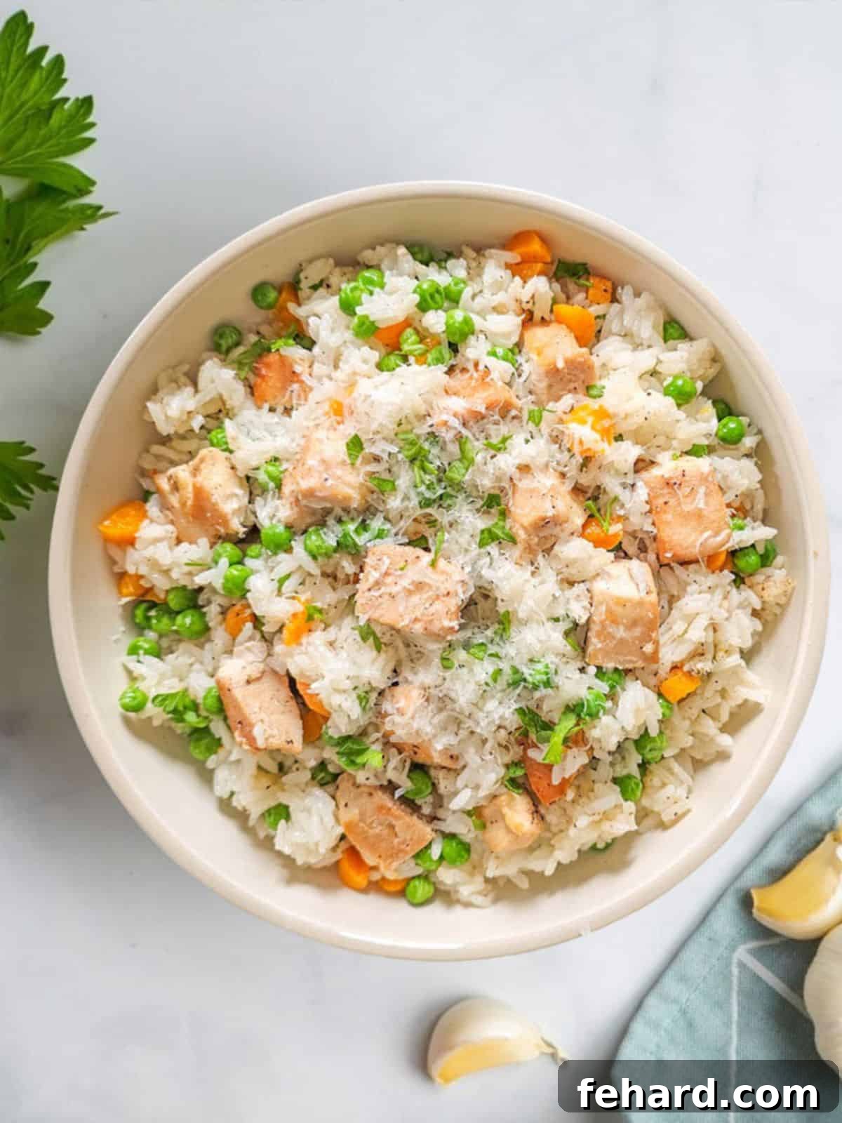 Instant Pot Chicken and Rice A beautifully plated bowl of Instant Pot Chicken and Rice, garnished with fresh herbs. Garlic cloves are scattered in the background, hinting at the delicious flavors within.
