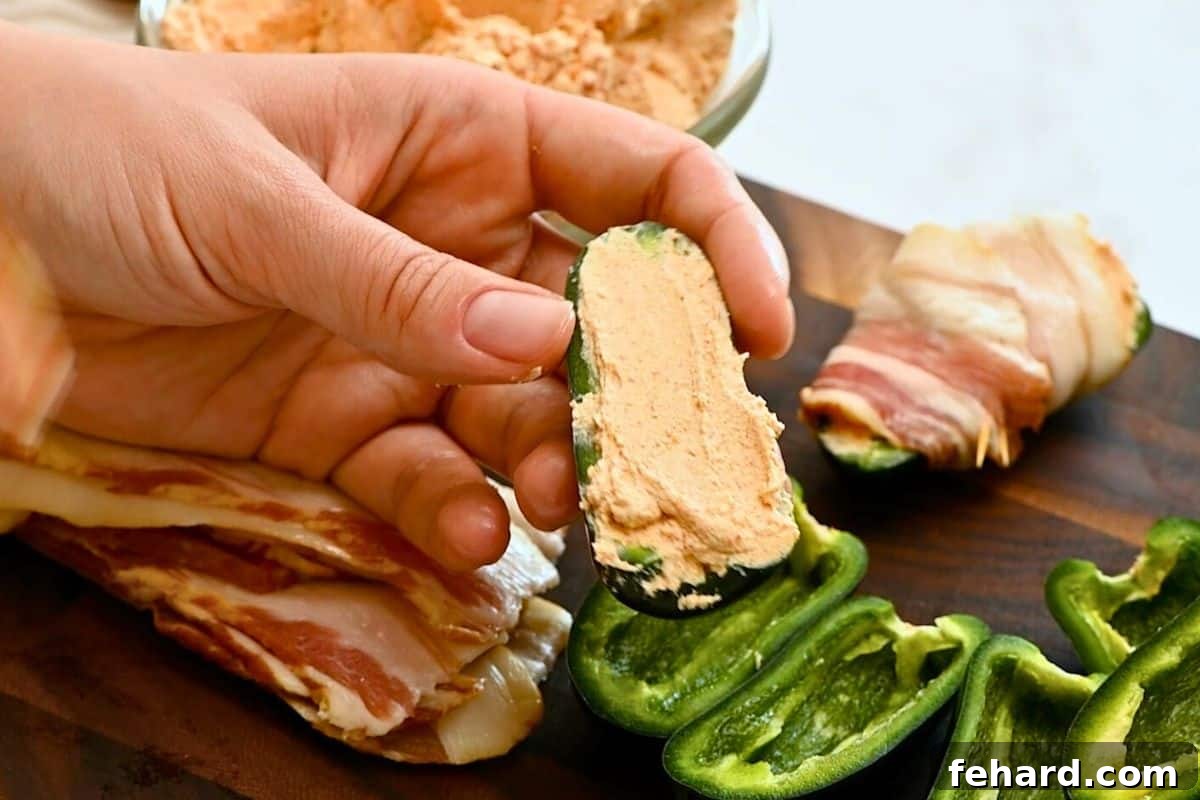 Jalapeno Popper Recipe Grilled Jalapeno hollowed out and stuffed with spiced cream cheese in pepper cavity.