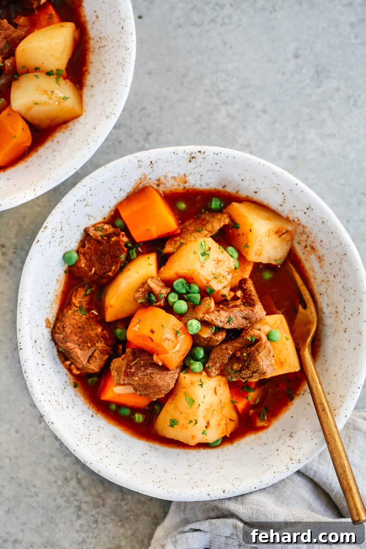 White bowl with healthy slow cooker beef stew inside.