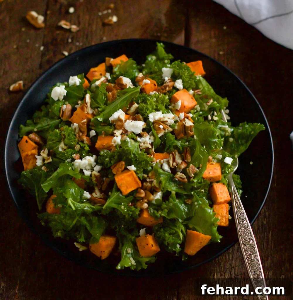 Hearty Roasted Sweet Potato Kale Salad with roasted sweet potatoes, massaged kale, pecans, and feta cheese.