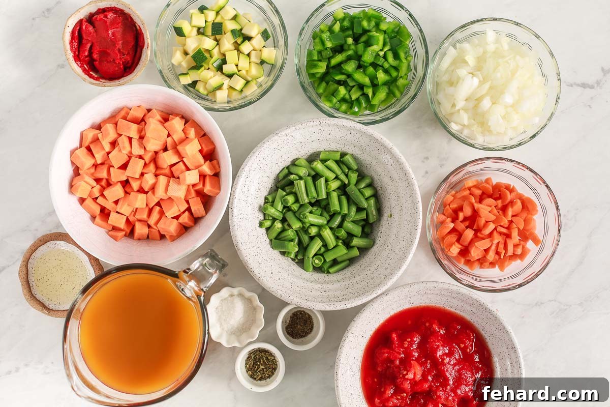 Bowls filled with fresh ingredients for chicken vegetable soup.