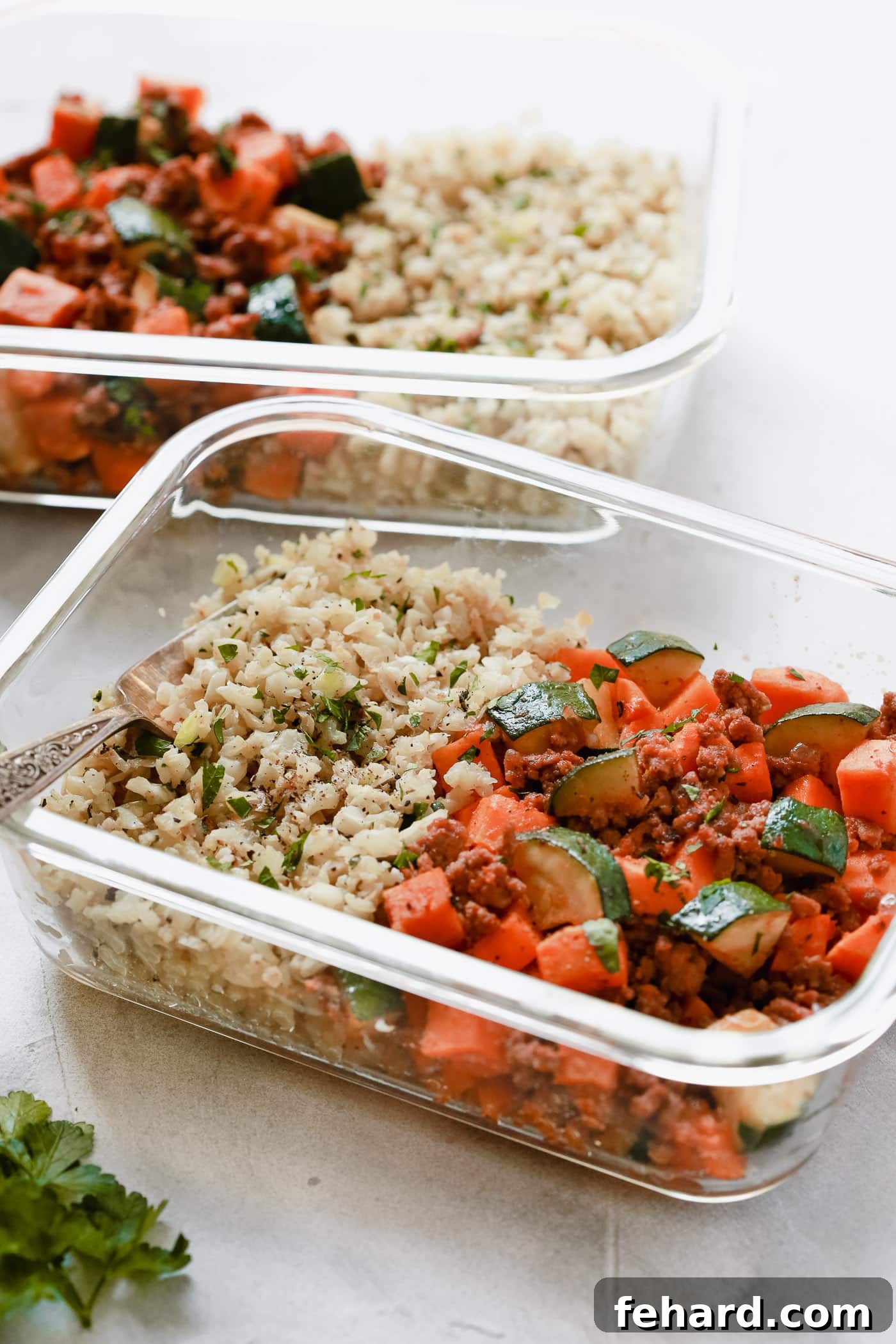 Smart Meal Prep: Ground Beef, Zucchini & Sweet Potato Skillet 5 Ground Beef Zucchini Sweet Potato Skillet in a glass meal prep container, garnished with fresh parsley, emphasizing a healthy and balanced meal.