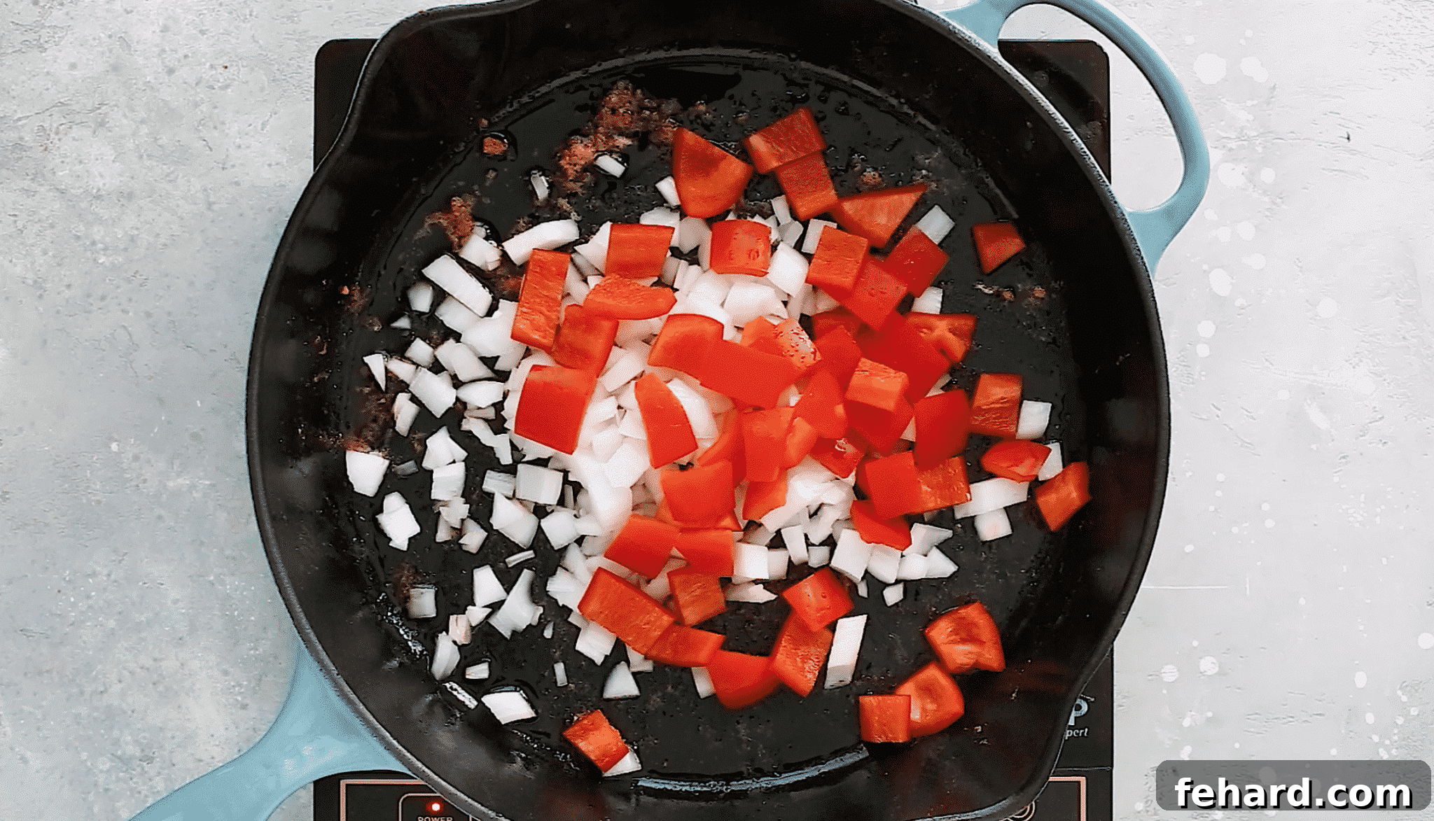 overhead view of a cast iron skillet with veggies inside of it.