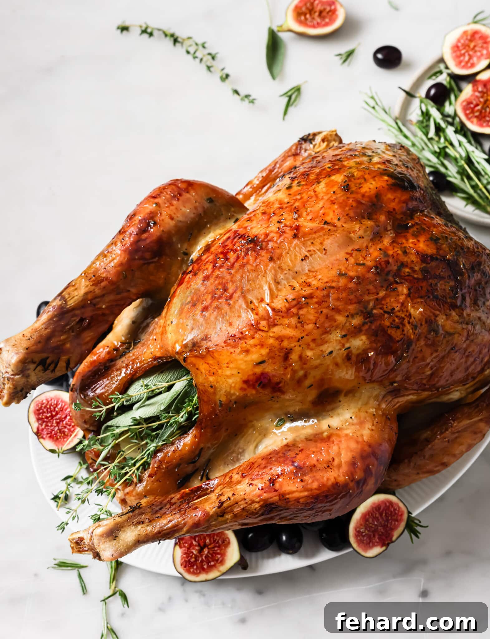 Garlic butter roasted turkey on a serving platter. 